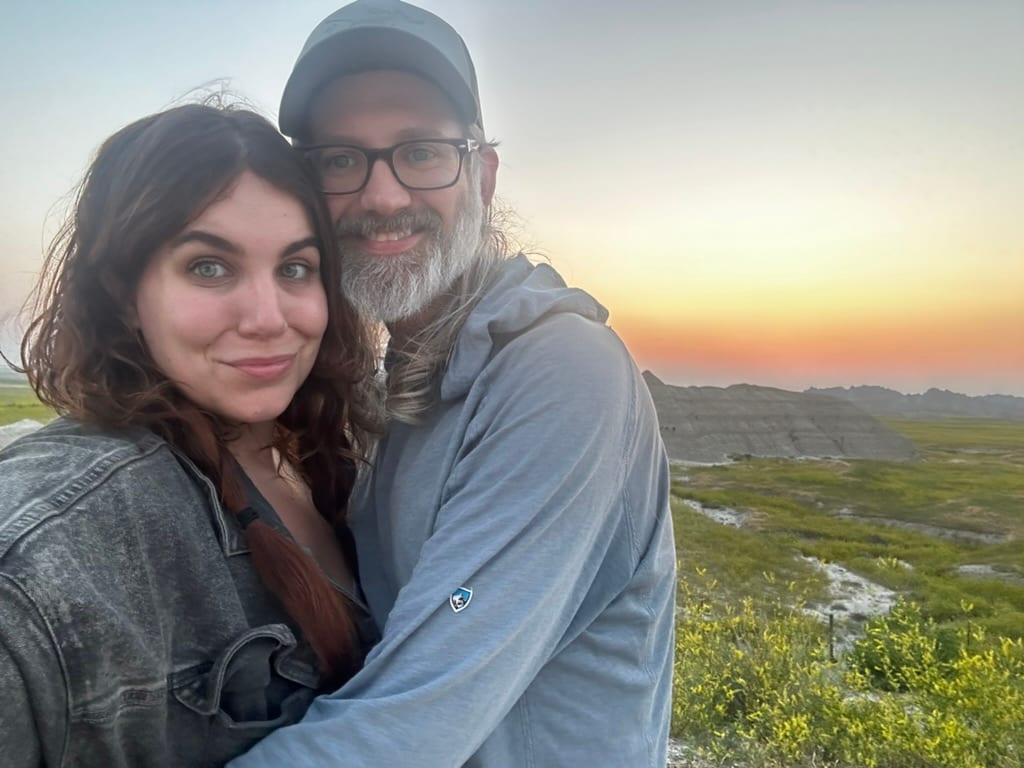 Steve and Nichole at sunset above a green valley