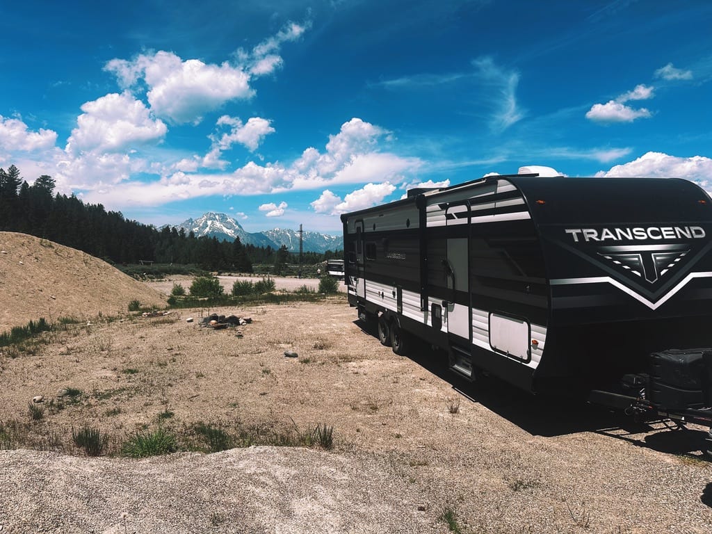 Their travel trailer parked beneath the mountains